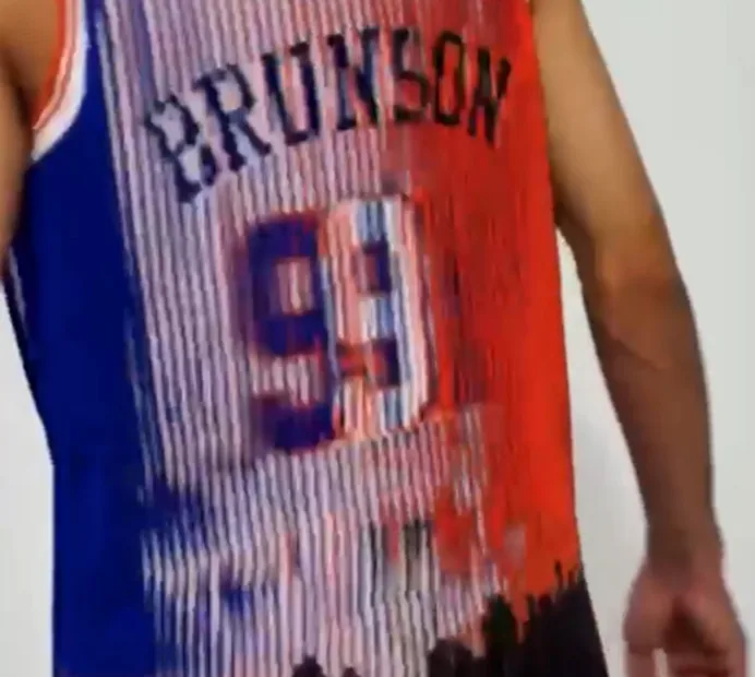 The jersey's back mid-turn: the name and two numbers, 9 and 11, blending in the ribs, half blue and half orange.