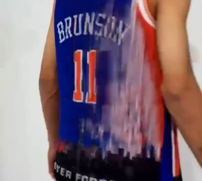 The jersey's back from the other side, now reading fully in blue, number 11 over the skyline hem.